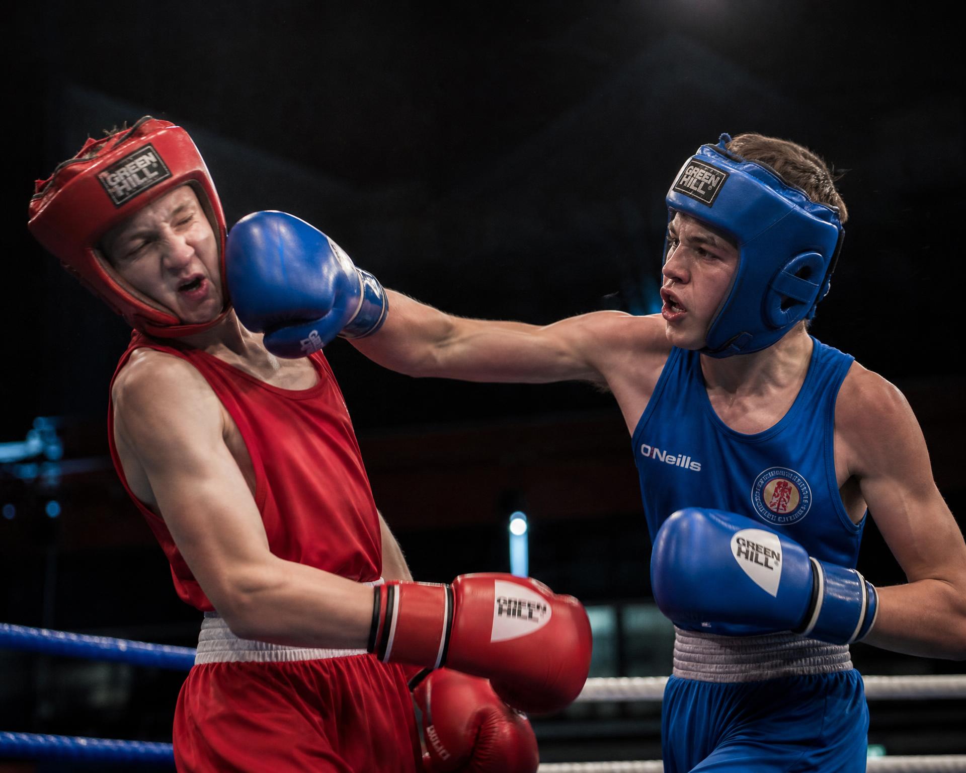 Youth boxers sparring in a competition ring